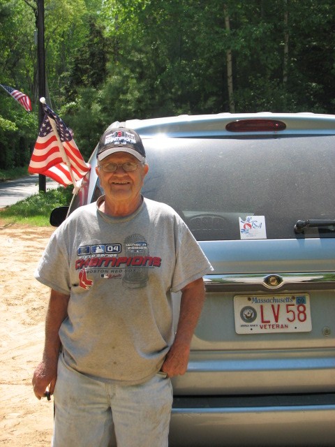 WWII veteran Jack Normand and his truck with the VETERAN plates and the flag