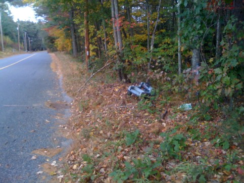 toy pedal car dumped on the side of East Brimfield Road