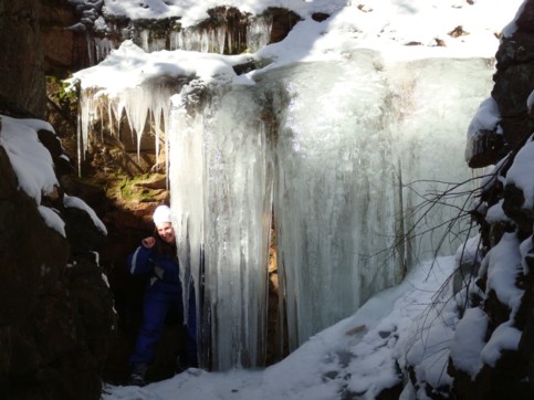 Icicles reaching into the mine cut, Dana hiding behind the curtain of ice.