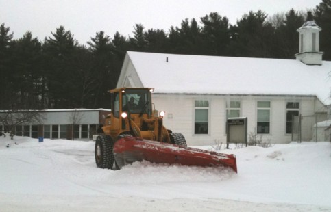 Alexander Haney operating the heavy front loader in front of Holland Elementary School